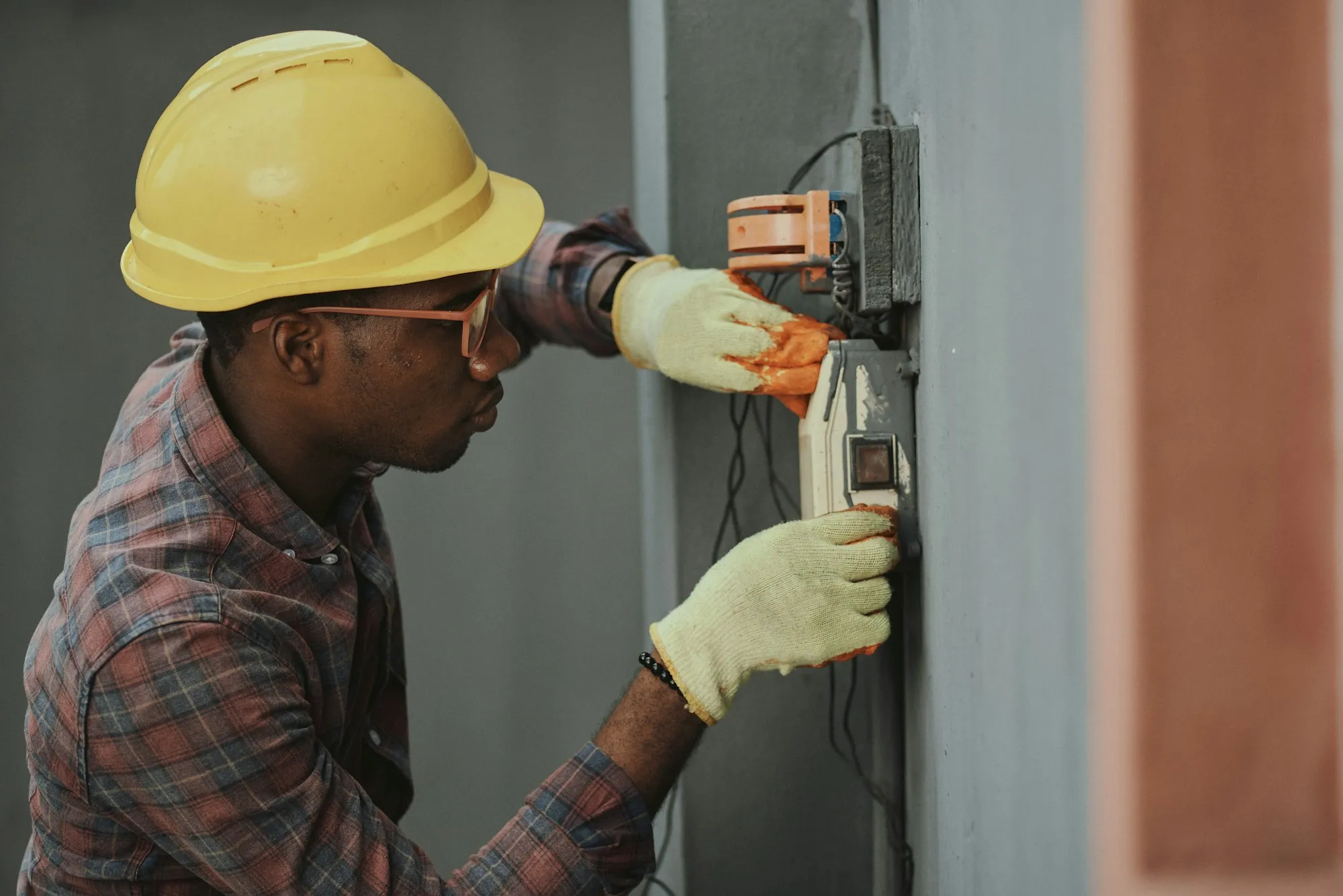 Home service tradesperson in a work hat holding a power tool, representing local plumbers, electricians, and contractors who rely on a strong website to generate leads