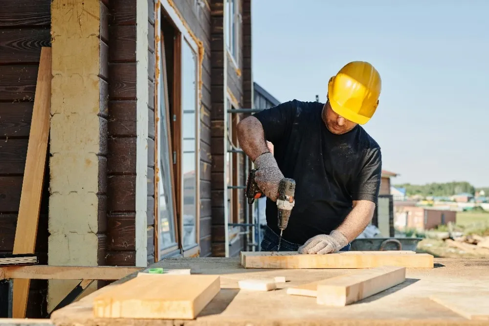 General contractor reviewing blueprints on a construction site